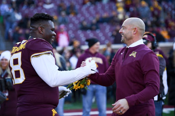 Gophers coach P.J. Fleck greeted defensive lineman Micah Dew-Treadway during a Senior Day ceremony before the Wisconsin game.