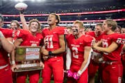 Mankato-West High School players celebrate after defeating Mahtomedi High School 24-10 in the Minnesota High School football Class 5A State Championsh