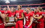 Mankato-West High School players celebrate after defeating Mahtomedi High School 24-10 in the Minnesota High School football Class 5A State Championsh