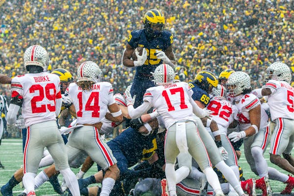 Michigan running back Hassan Haskins (25) leapt over Ohio State defenders for a touchdown in last year’s 42-27 victory for the Wolverines.