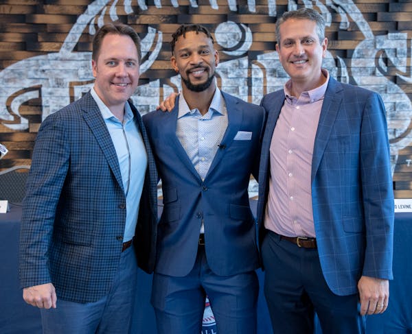 Twins bosses Derek Falvey, left, and Thad Levine flanked Byron Buxton after signing him to a $100 million contract extension Wednesday. They’ll focu