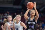 Hopkins’ Maya Nnaji went to the basket despite defensive pressure from Cambridge-Isanti’s Amme Sheforgen, left, and Jana Swanson during the second