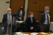 The defense team stands as potential jurors enter the courtroom during the manslaughter trial of former Brooklyn Center police officer Kimberly Potter
