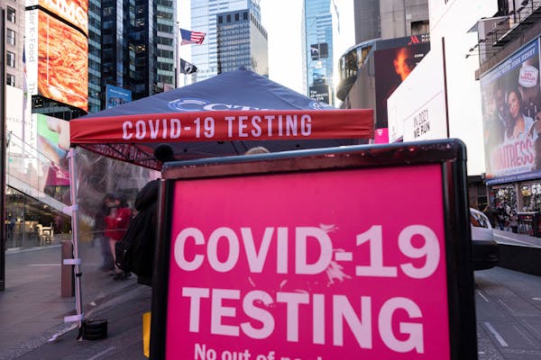 A sign of COVID-19 testing site is seen in Times Square on Friday, Dec. 3, 2021, in New York. 