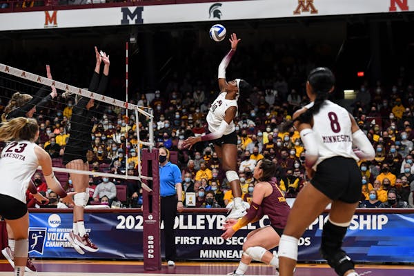 Gophers opposite hitter Stephanie Samedy leaps to spike the ball against Stanford during the first set Saturday night.