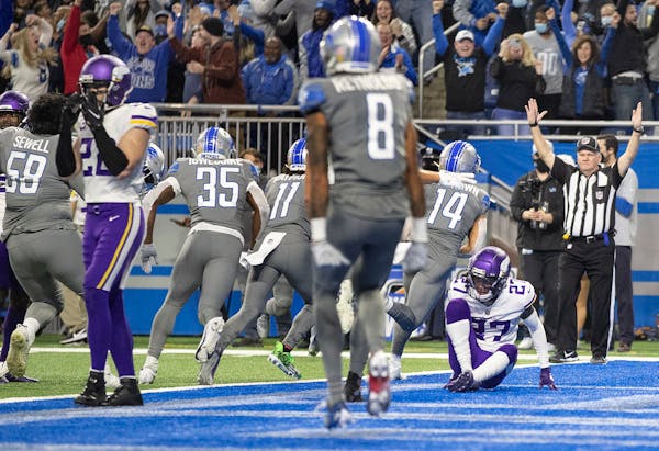 Detroit wide receiver Amon-Ra St. Brown (14) celebrates his game-winning touchdown in the fourth quarter over the Vikings.