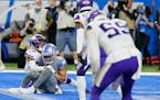 Lions receiver Amon-Ra St. Brown, defended by Vikings cornerback Cameron Dantzler, catches a 11-yard pass for the winning touchdown Sunday.