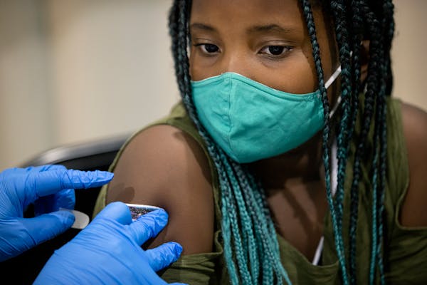 Naomi Everman, 8, of Falcon Heights received a COVID-19 vaccine shot Thursday at Mall of America in Bloomington.