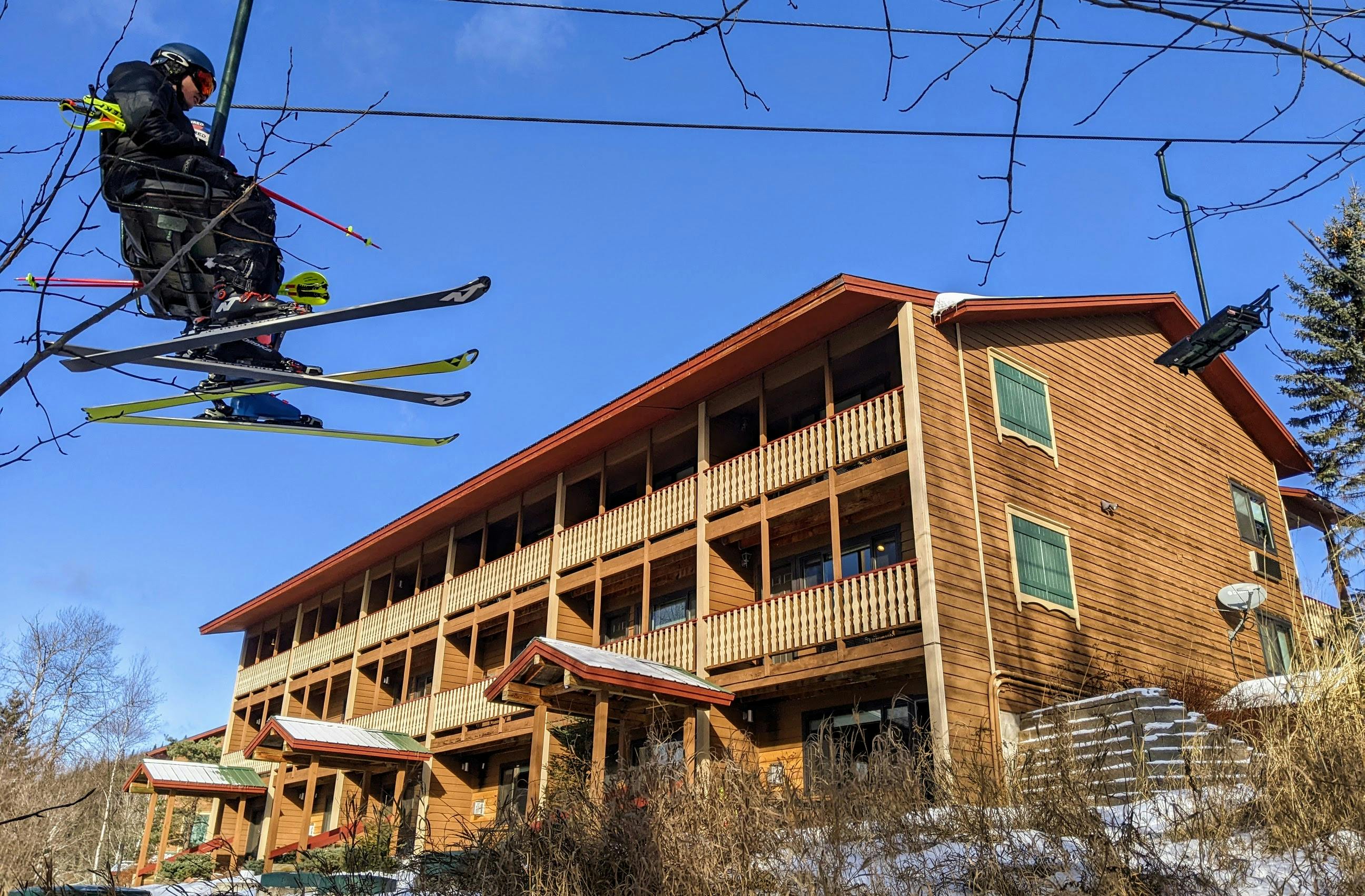 Skiers ride the chairlift past one of the buildings of Eagle Ridge Resort at Lutsen.