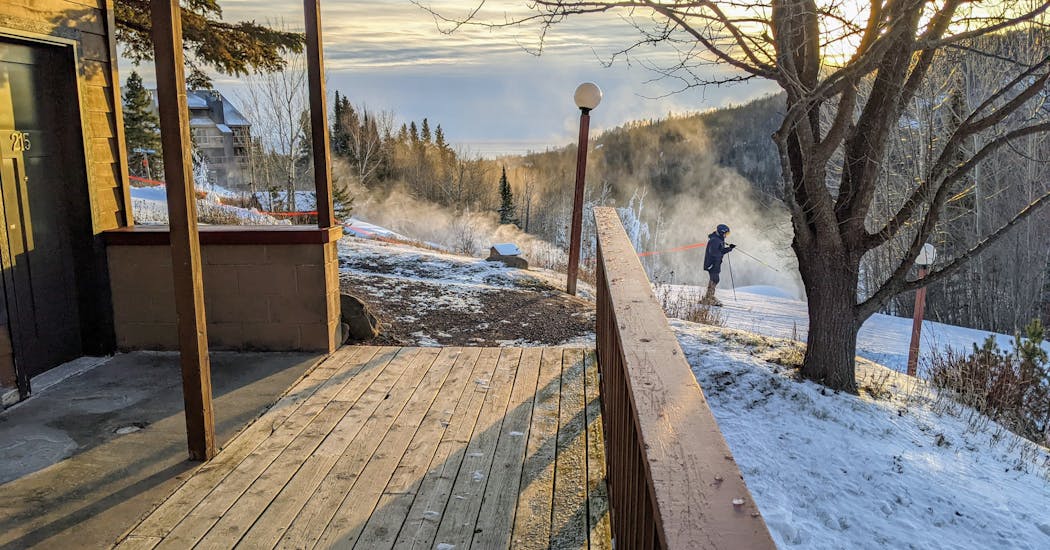 A skier zips past the ski-in, ski-out lodging at Eagle Ridge Resort at Lutsen.