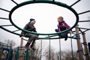 Frannie, left, and Luci Howatt played on the playground equipment at Galtier Community School in St. Paul in 2020. The playground is seen as a social 