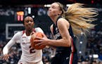 Connecticut’s Paige Bueckers, right, drives past Arkansas’ Samara Spencer in the second half of an NCAA college basketball game on Nov. 14. Buecke
