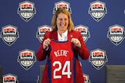Minnesota Lynx head coach Cheryl Reeve stands for photos with her ceremonial jersey during a press conference to announce she’d been named the head 
