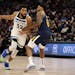 Minnesota Timberwolves center Karl-Anthony Towns (32) handles the ball against Utah Jazz forward Rudy Gay (8) during the second half of an NBA basketb