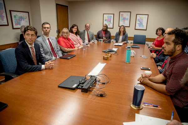 Minneapolis Mayor Jacob Frey, left, and the City Council pictured after a closed meeting in 2019.