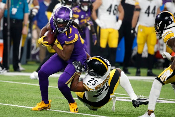 Vikings wide receiver K.J. Osborn is tackled by Steelers cornerback Ahkello Witherspoon during the first quarter.
