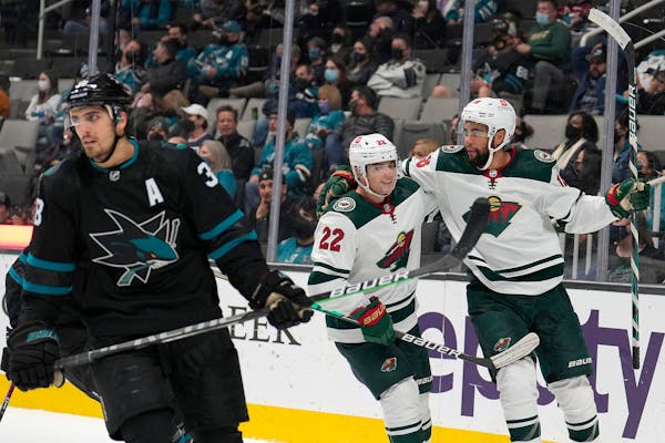 Wild left wing Jordan Greenway, right, is congratulated by Kevin Fiala (22) after scoring a goal against the San Jose Sharks during the second period