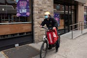 A delivery man biked with a food bag from Grubhub in New York in April. With pandemic emergency regulations soon expiring, the Minneapolis City Counci