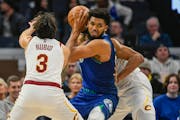 Wolves center Karl-Anthony Towns looke to pass the ball while covered by former teammate Ricky Rubio in the second half Friday.