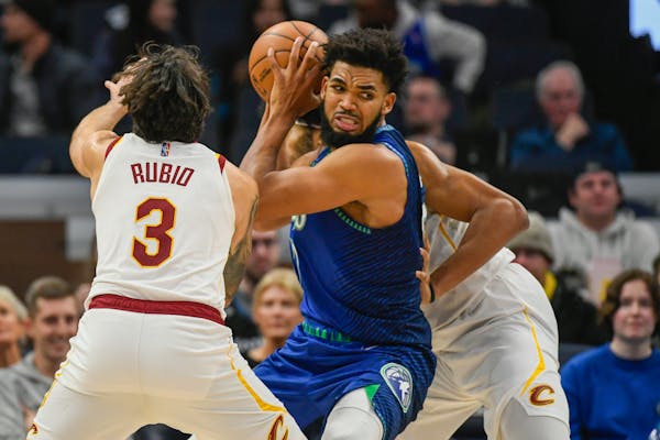 Wolves center Karl-Anthony Towns looke to pass the ball while covered by former teammate Ricky Rubio in the second half Friday.