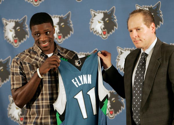 In this June 26, 2009 photo, Minnesota Timberwolves David Kahn, right, president of basketball operations, presents a jersey to first round draft pick