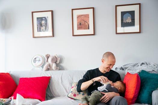 Seth Snyder feeds his 8-month-old son with donated breast milk in their home in Minneapolis. Snyder’s wife, Radikha, died by suicide in July after s