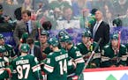 Brett McLean huddled with Wild players during a game in 2021 at Xcel Energy Center.