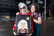 Comedian Lizz Winstead, left, holds her portrait made by crop artist Christy Klancher in downtown Minneapolis. The two creatives first met six years a