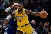 Lakers forward LeBron James works to the basket around Timberwolves forward Jarred Vanderbilt on Friday