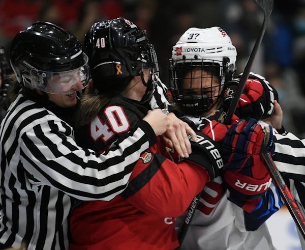 Officials got their arms around Canada’s Blayre Turnbull (40) and United States’ Abbey Murphy (37) during a shoving match when the teams met on No