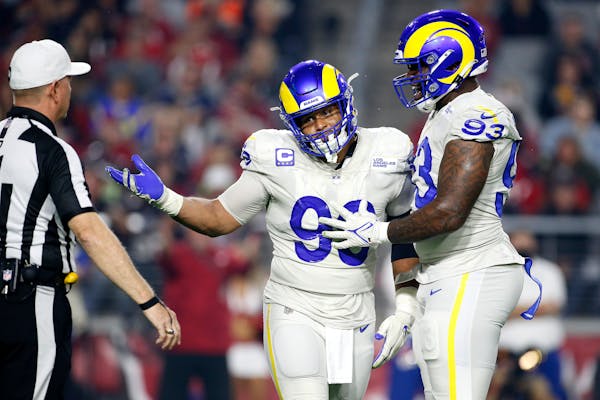 Rams defensive tackle Aaron Donald, left, celebrates a sack with defensive end Marquise Copeland on Dec. 13 against the Cardinals.