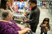 Khyber Sakhi helped Cyndel Bast and her mother Joyce Scott of Sumner, Iowa, with a cellphone accessory at the Mall of America. His daughter Fathima, 3