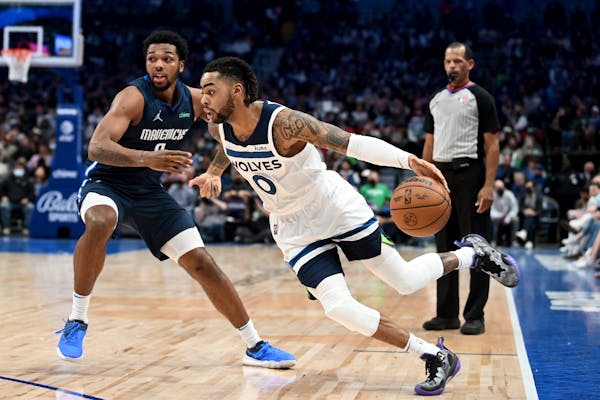 Mavericks forward Sterling Brown defends as Timberwolves guard D’Angelo Russell handles the ball in the second half Tuesday.