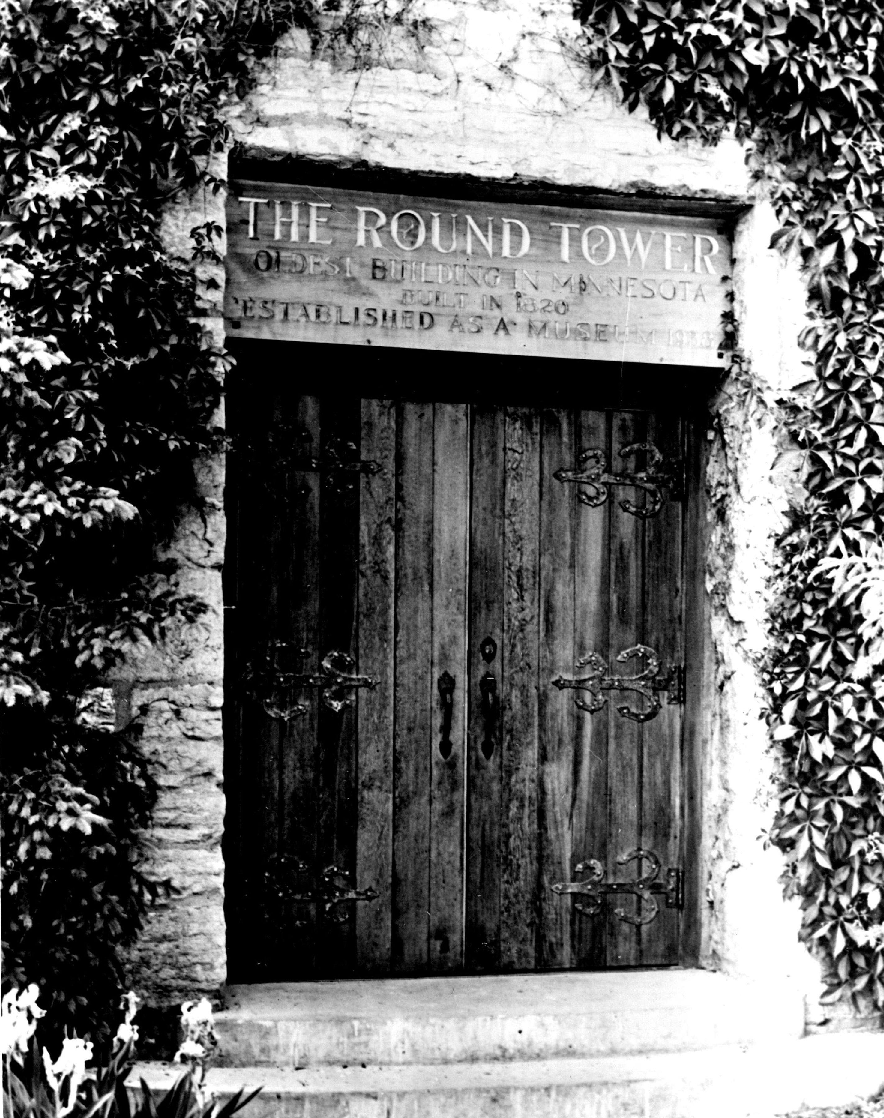 The entrance to the Round Tower in 1954. The sign above the door states it is the oldest building in Minnesota.