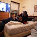 Shuntay Thomas explained sound mixing to his son Brandon, 10, as they listened to music in their room in the Project Home at the Provincial House in S