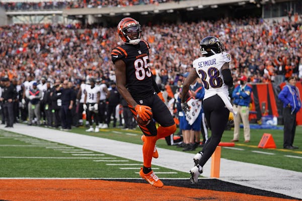 Tee Higgins of the Bengals caught a touchdown pass from Joe Burrow on Sunday against Ravens defensive back Kevon Seymour.