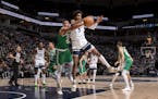 Al Horford (42) of the Celtics and Jaden McDaniels (3) of the Timberwolves fought for the ball during the Wolves’ victory Monday night at Target Cen