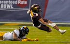 Gophers running back Ky Thomas was tripped up by West Virginia cornerback Daryl Porter Jr. in the Guaranteed Rate Bowl. Thomas scored on a 5-yard run 
