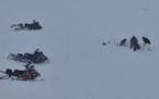 Rescue personnel worked to recover a sled caught in an avalanche Monday in south-central Montana.
