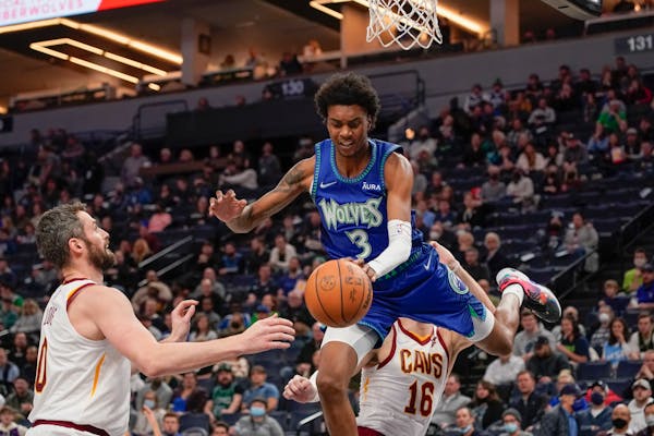 Jaden McDaniels of the Wolves was fouled by Cleveland’s Cedi Osman on Dec. 10 at Target Center.