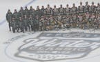 Wild players and coaches posed for a photo during a Winter Classic practice Friday at Target Field.