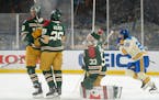 The Wild’s Jordan Greenway (left) and Dmitry Kulikov (29) arrived too late to help Wild goalie Cam Talbot stop one of the Blues’ five second-perio