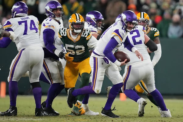 Minnesota Vikings quarterback Sean Mannion (14) broke out of the tackle as he rushed the ball in the second quarter of an NFL game between the Minneso