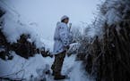 A Ukrainian soldier looked on at a fighting position on the line of separation from pro-Russian rebels, Donetsk region, Ukraine, Friday, Dec 31, 2021.