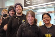 Neighborhood Cafe owner Kris Masanz, pictured with some of her staff, shut down for the first year of the pandemic. It’s been a slow trek back.