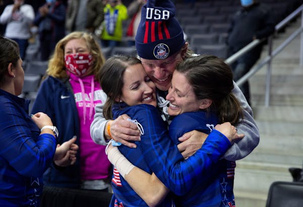 Edina natives Tabitha Peterson, left, and Tara Peterson, right, hugged their father, Sheldon Peterson, after winning the U.S. Olympic Curling Team Tri