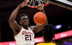 Illinois' Kofi Cockburn (21) dunks over Missouri's Jordan Wilmore during the first half of an NCAA college basketball game Wednesday, Dec. 22, 2021, i