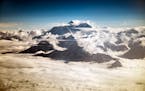 Mount Everest peeks above the clouds on a sightseeing flight, in Kathmandu, Nepal, May 16, 2017. 