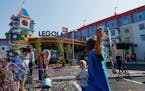 Children play with streamers and confetti from the official grand opening of the Legoland New York Hotel at the Legoland Resort on Aug. 6, 2021, in Go
