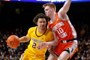 Minnesota guard Sean Sutherlin tries to move around Illinois guard Luke Goode during the first half of an NCAA college basketball game Tuesday, Jan. 4